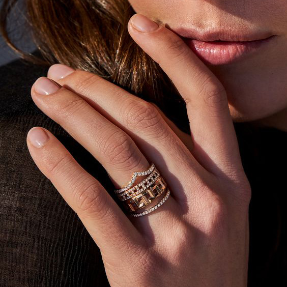 Woman wearing ring with finger on lip