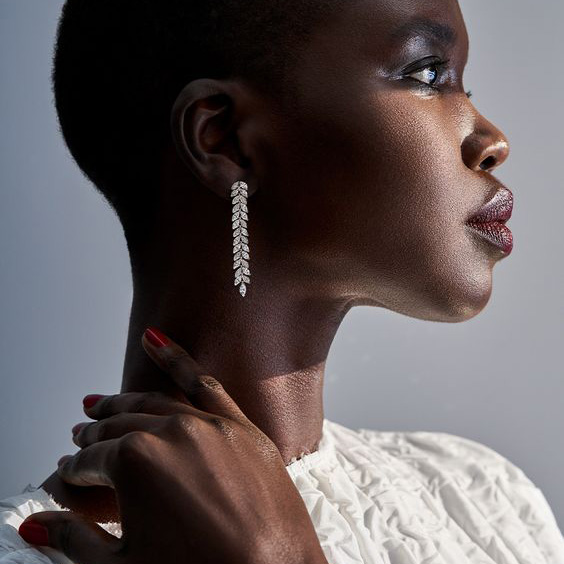 Woman side view wearing long silver earrings