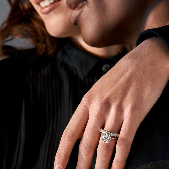 Woman wearing ring with arm over man